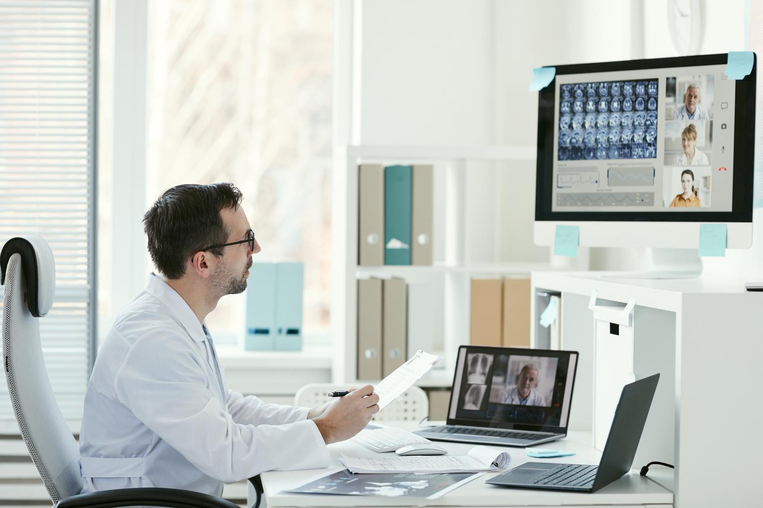 Doctor on a conference call looking at medical imaging