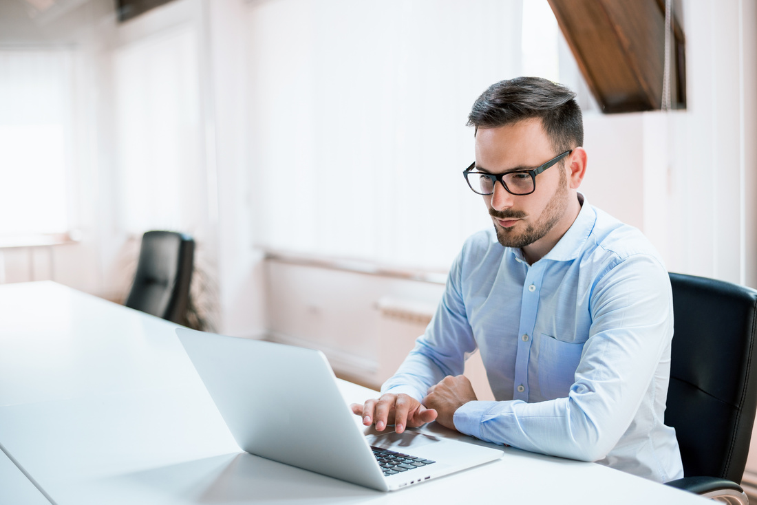  Young businessman working with laptop at office