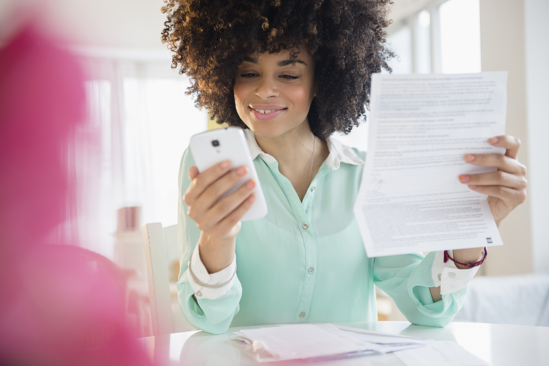 Woman paying bill with cell phone