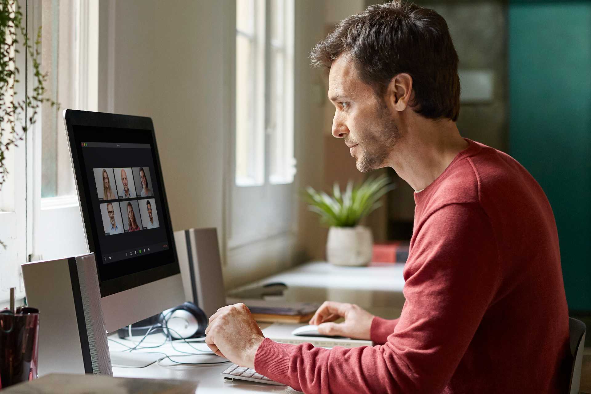 Man working from home on desktop computer