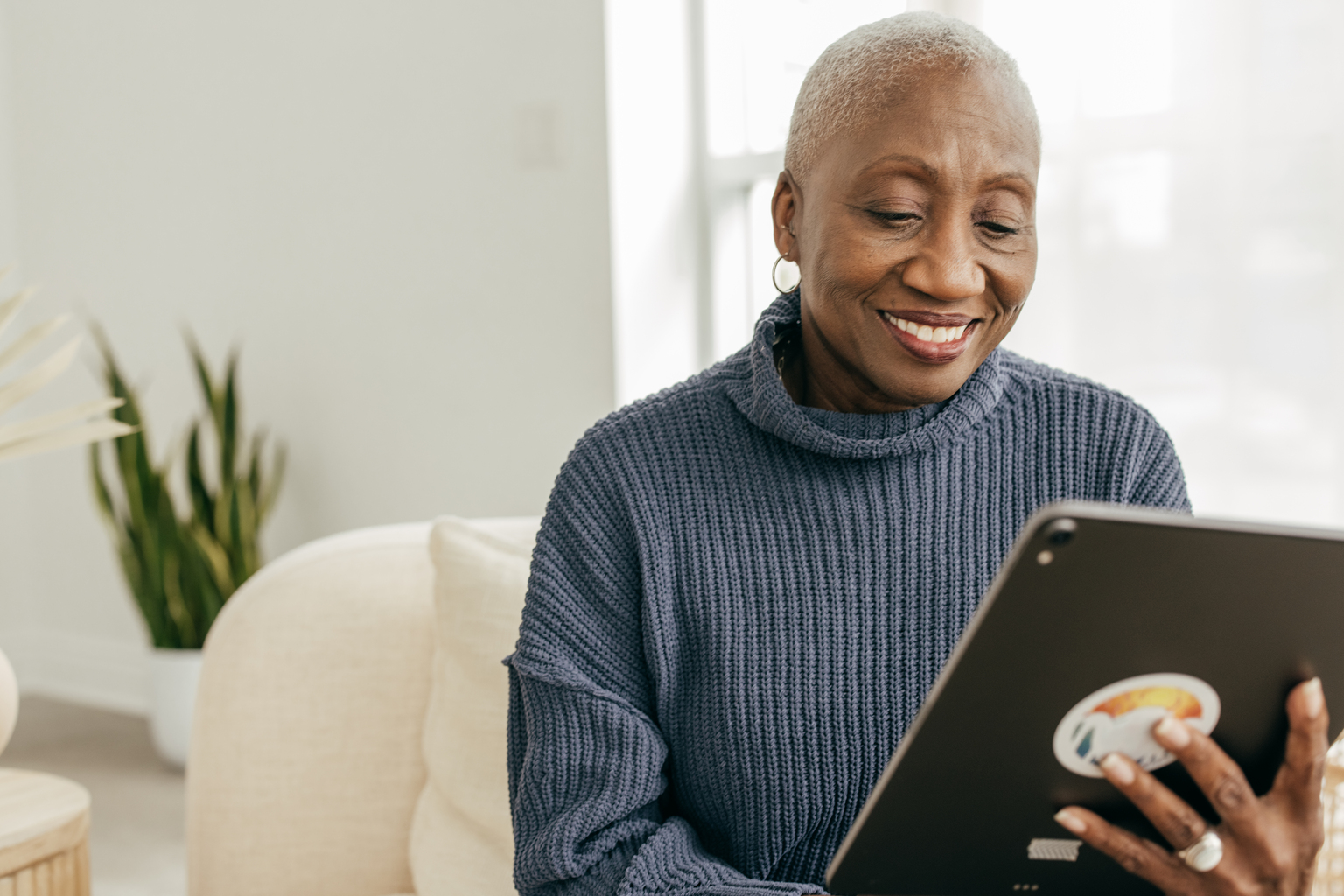 African American woman viewing a tablet.