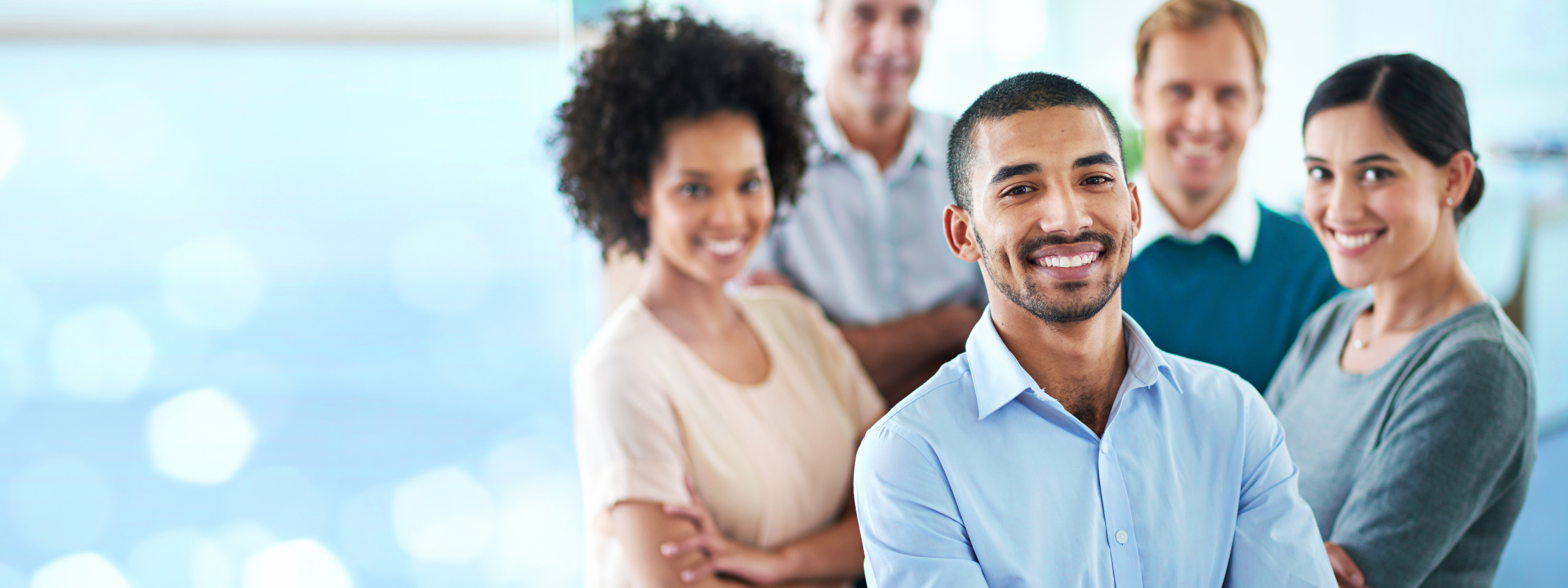 Portrait, happy and business people in office for solidarity, support or motivation with bokeh. Partnership, face and person team with diversity in solidarity for startup, management or collaboration.