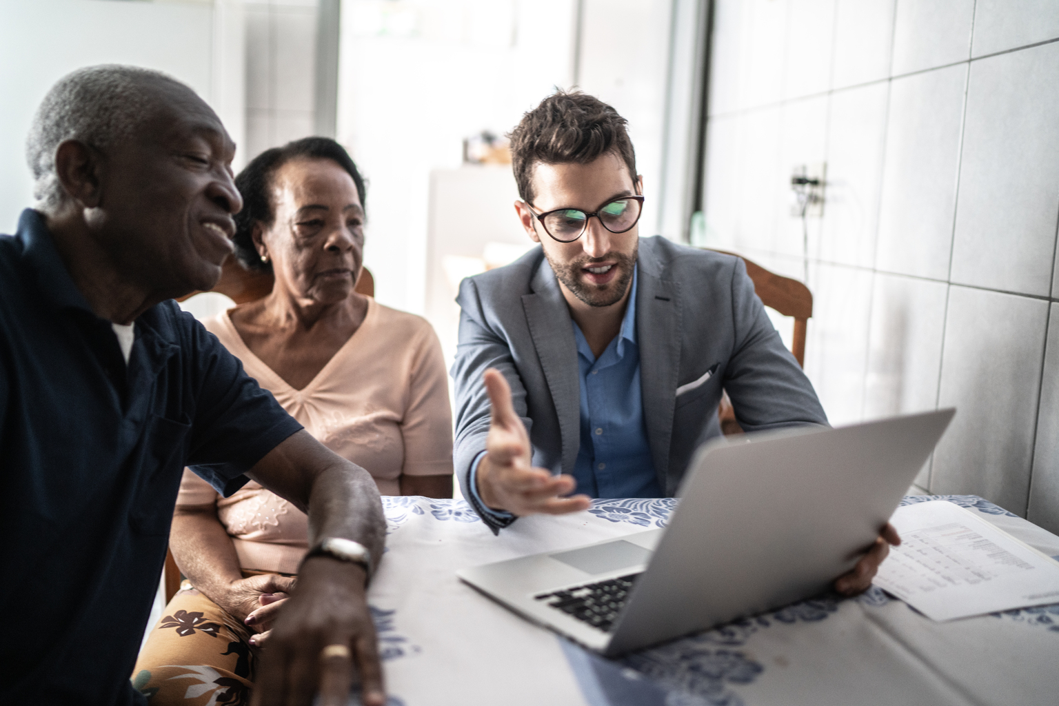 Senior couple having a consultation with a financial advisor at home