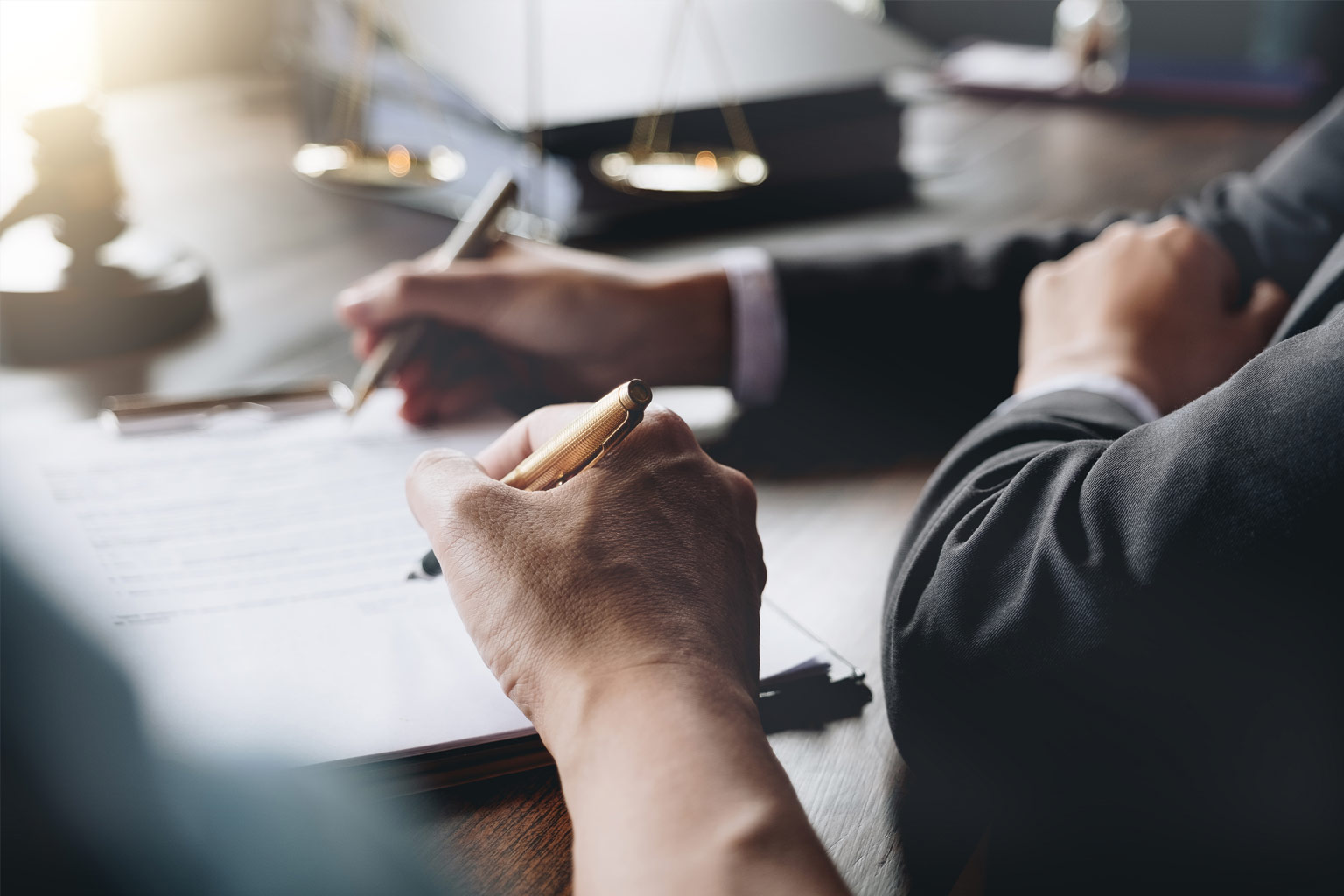 person writing on a document