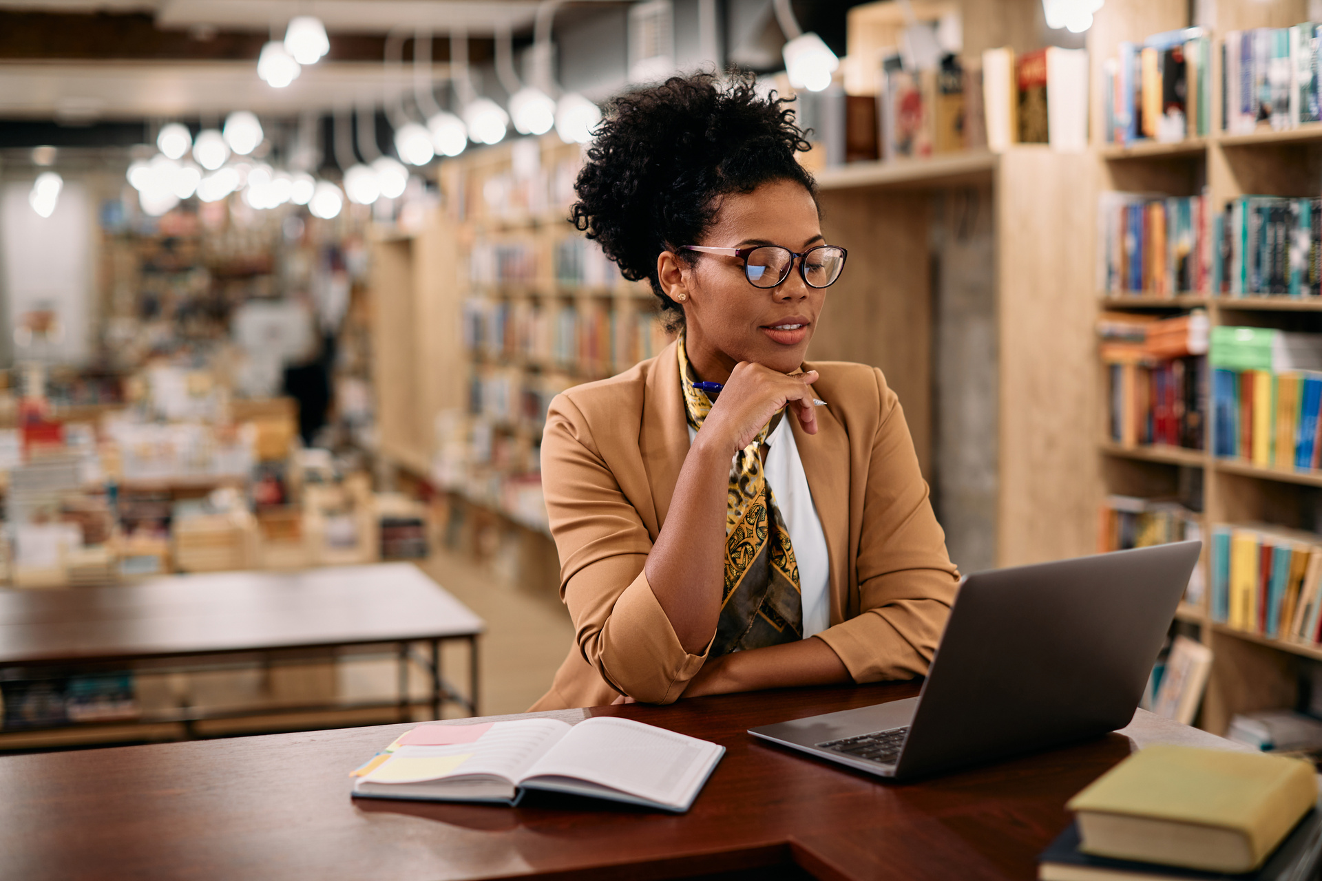 African American female professor using laptop while doing a research