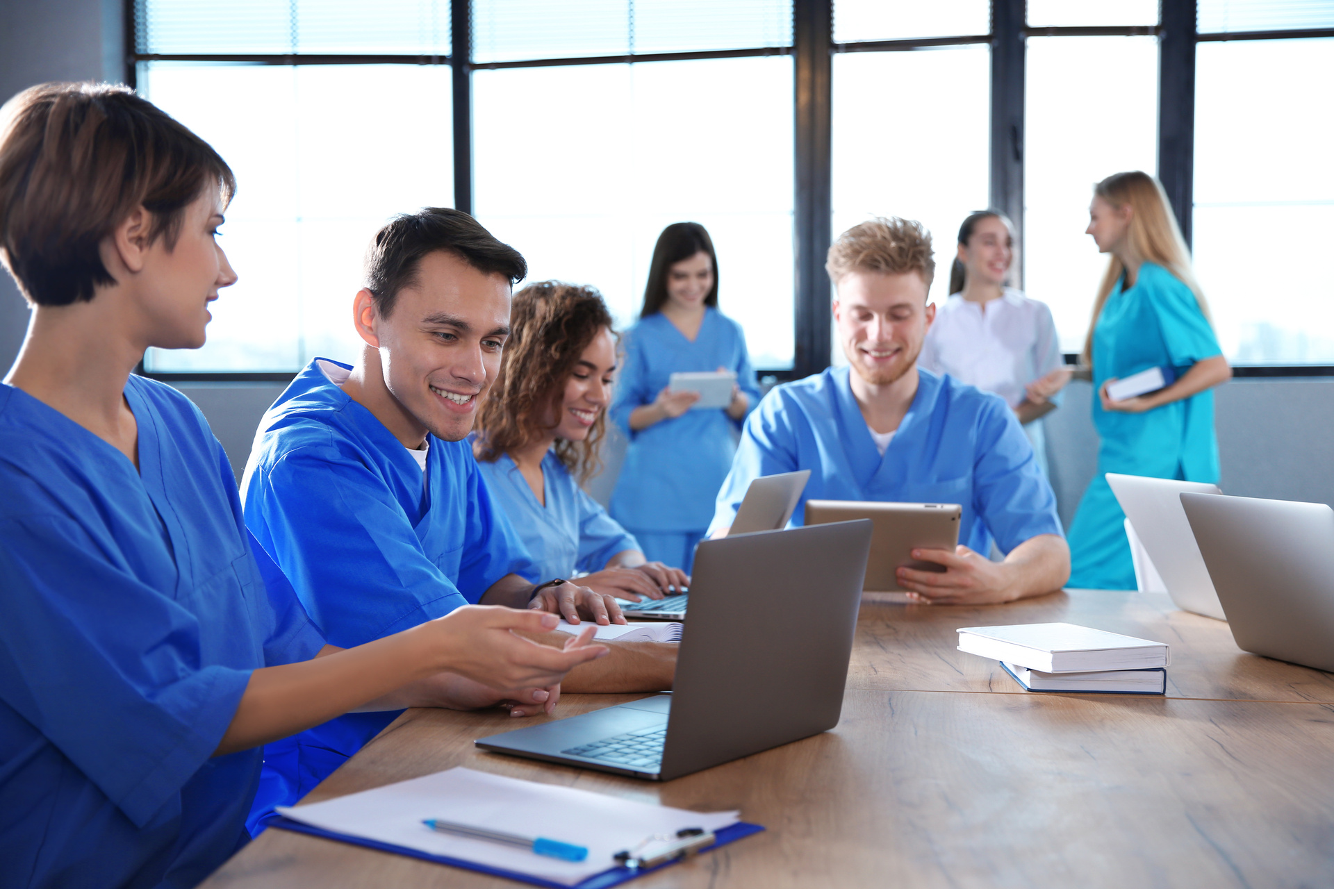 Group of medical students reviewing assignment on laptop