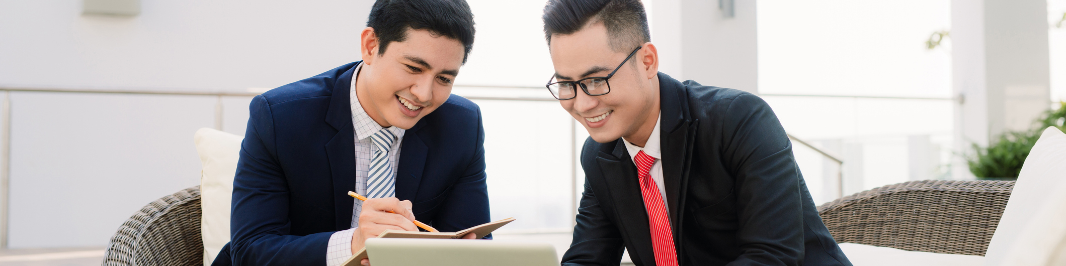 Cheerful smart businessmen discussing their project