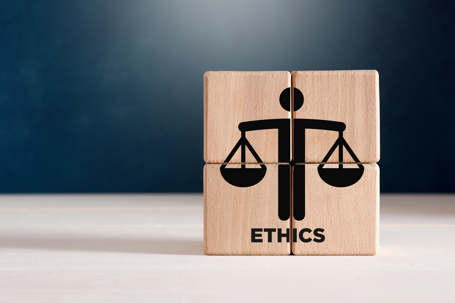 Business ethics or justice symbol on wooden cubes.