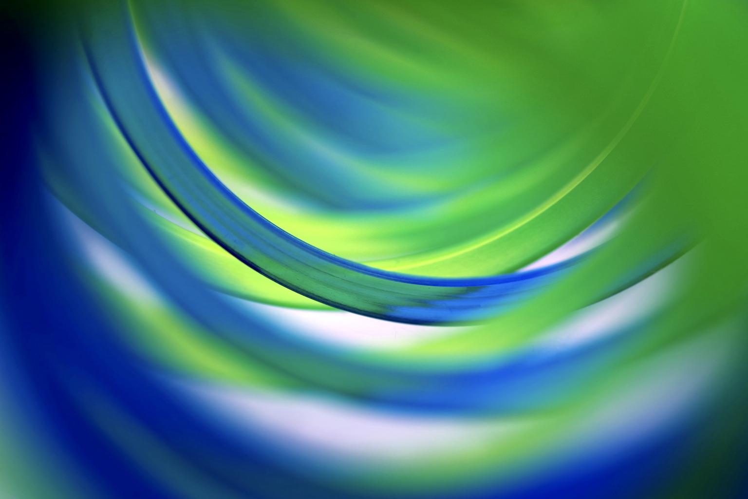 Extreme close-up inside two entwined green and blue coil spring toy