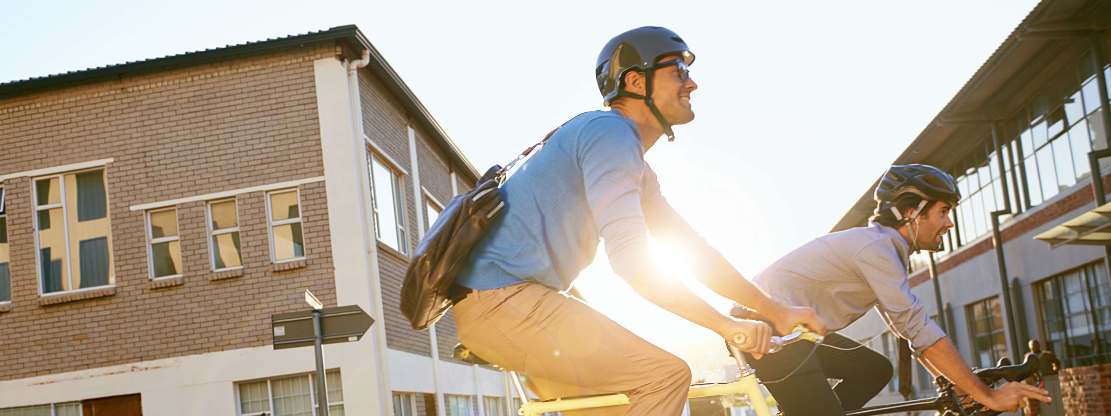 Shot of two young people cycling to work together