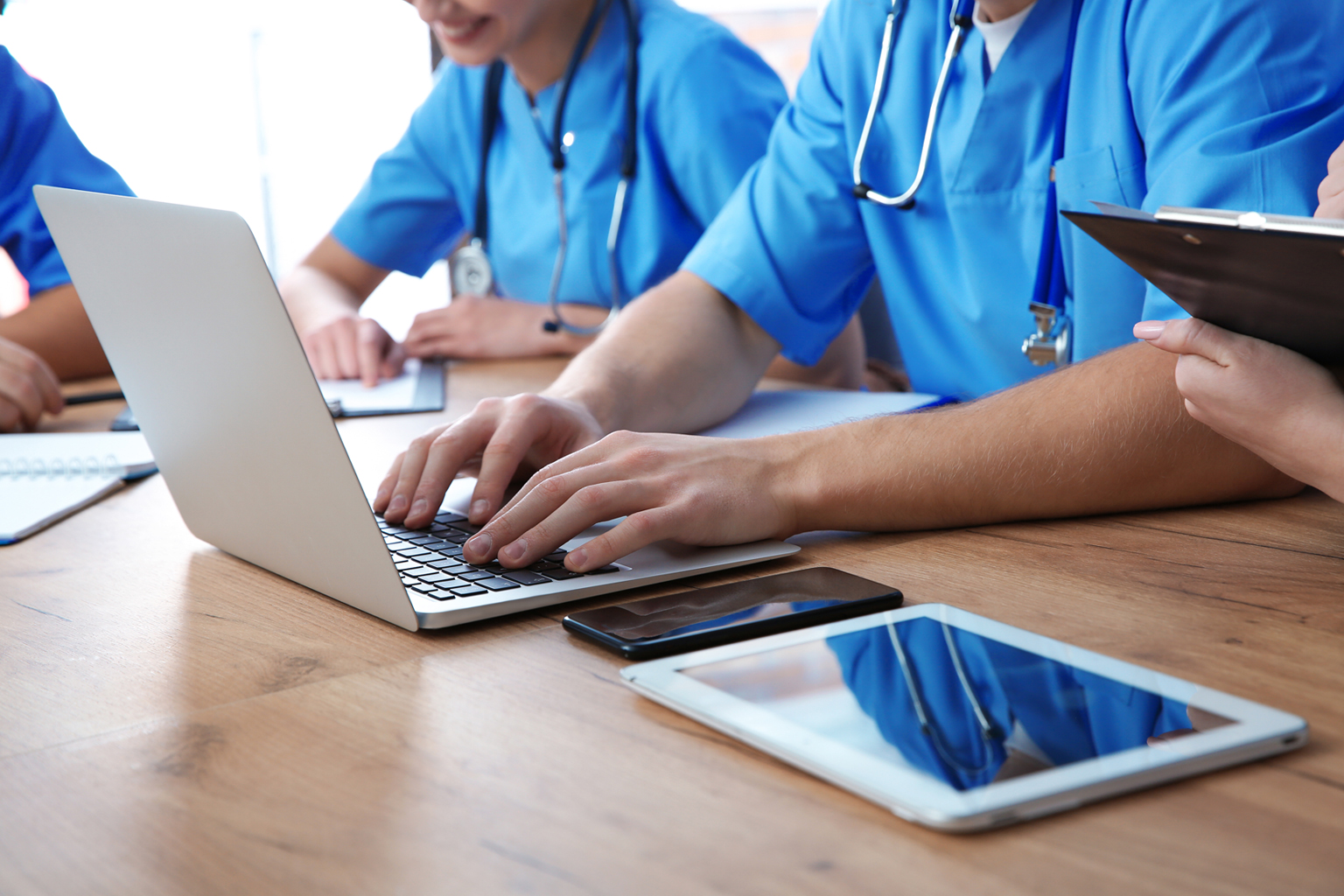 Medical students studying at table, closeup view