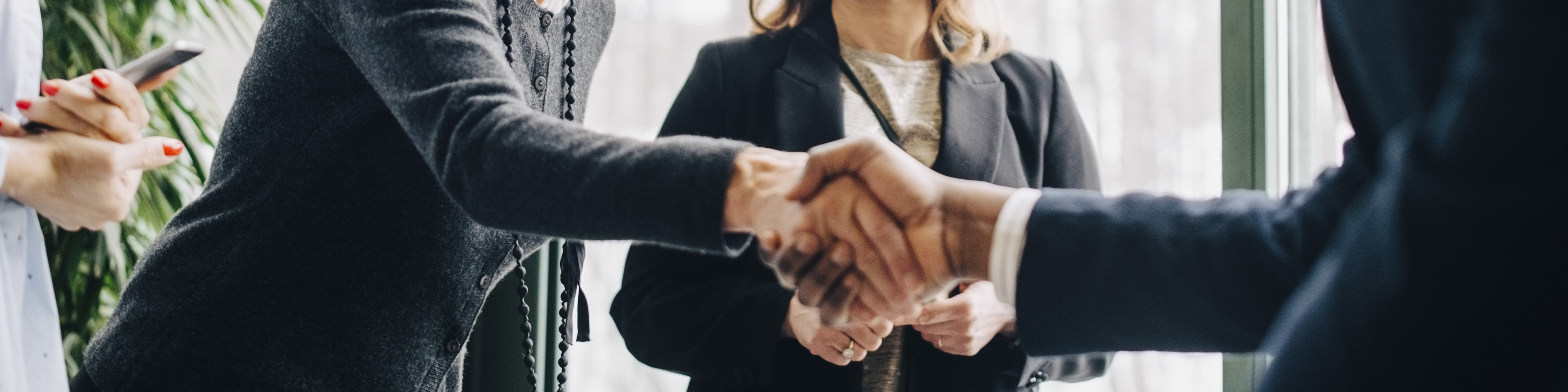 Senior businesswoman greeting colleagues during conference