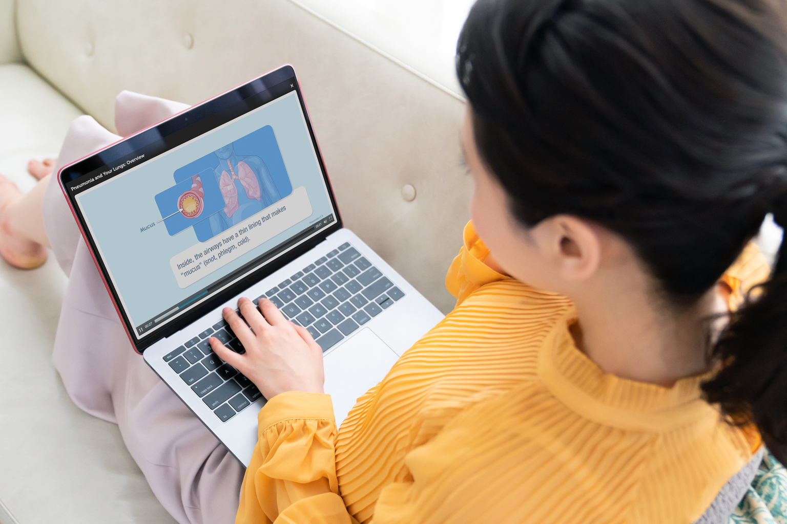 Young woman using a laptop in house, Emmi on the screen