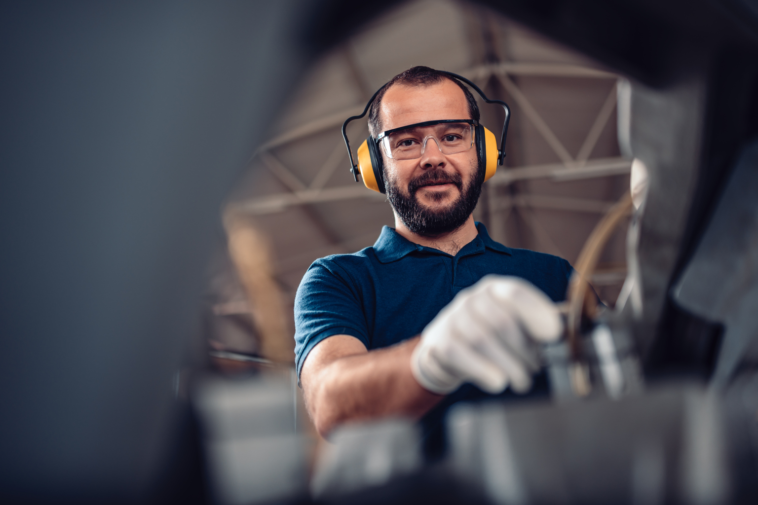 Engineer worker wearing protective glasses and headphones
