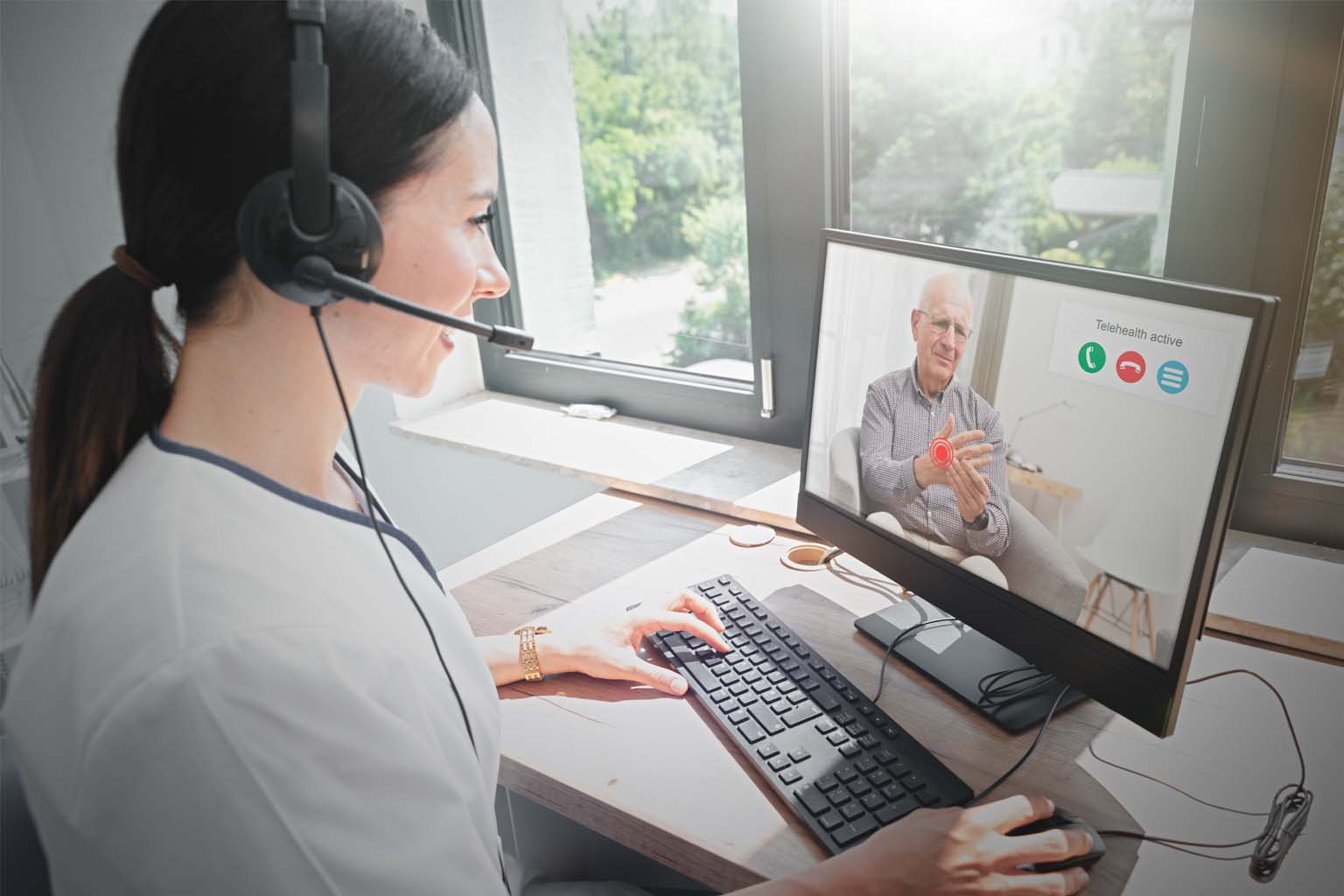 Health care provider at computer on video call with patient