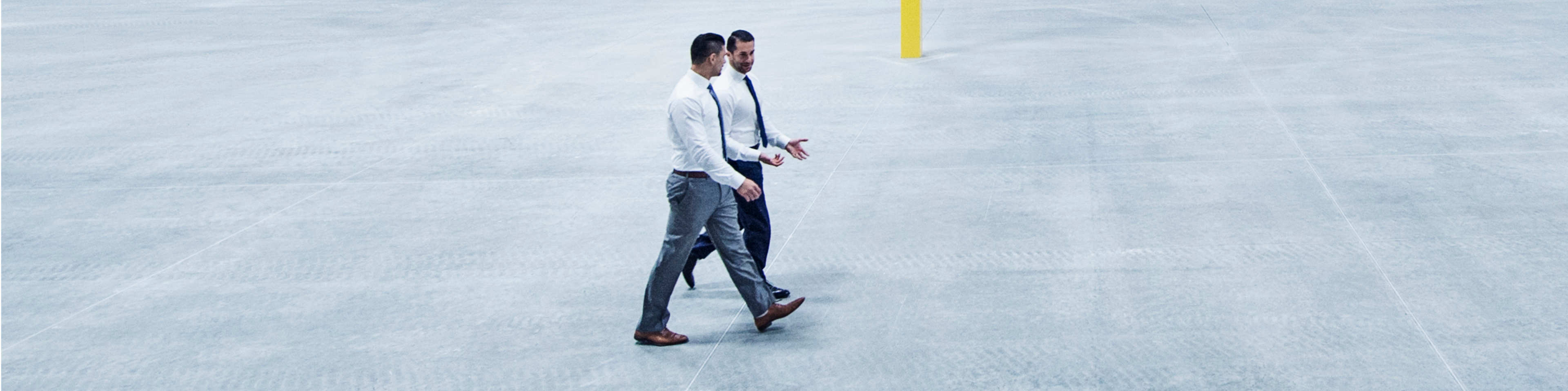 men walk through empty facility