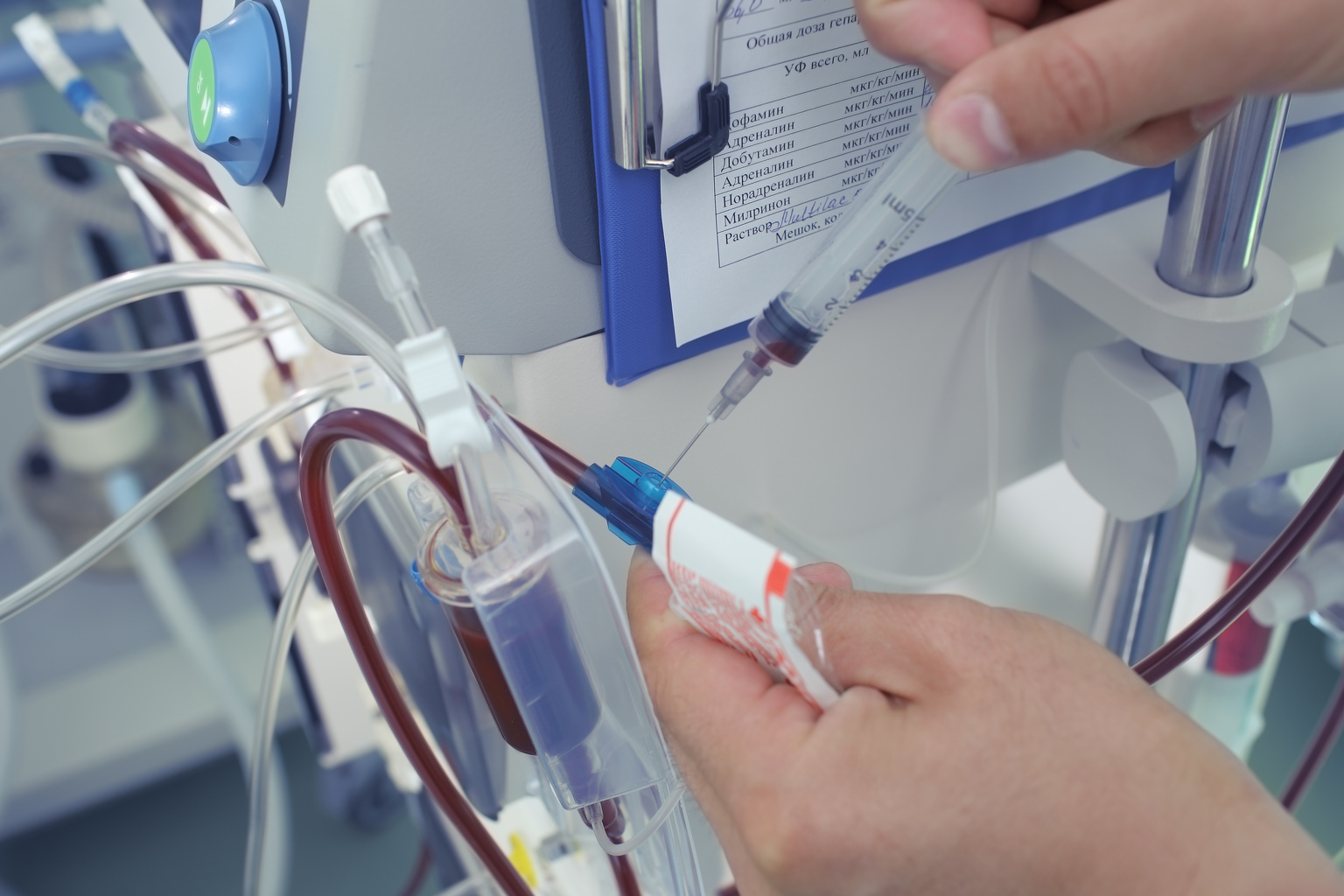 Doctor takes the blood sample from the dialysis tubing