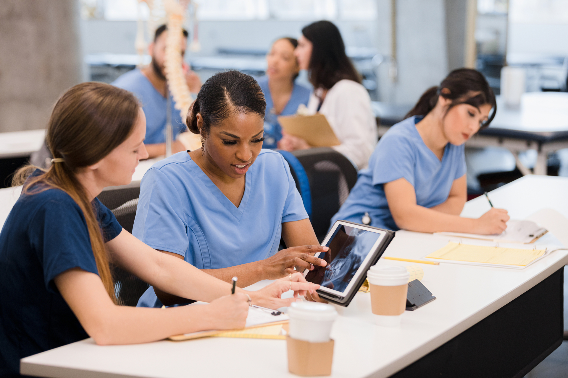 Two medical students using tablet to review medical image