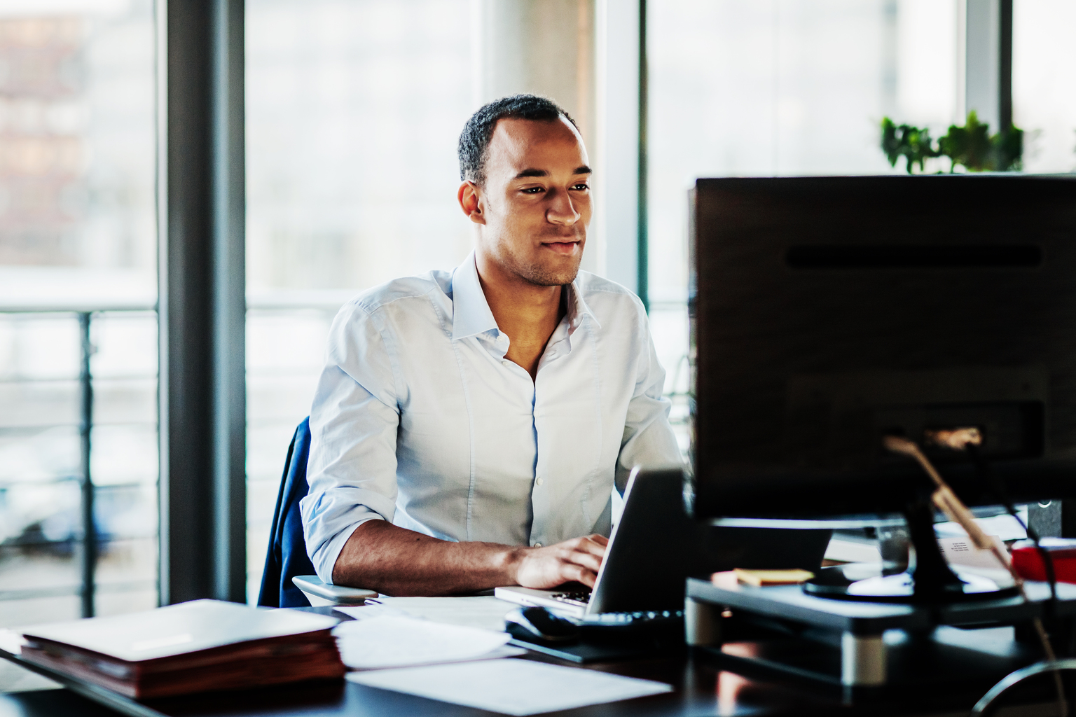 ffice Manager Working On Computer At His Desk