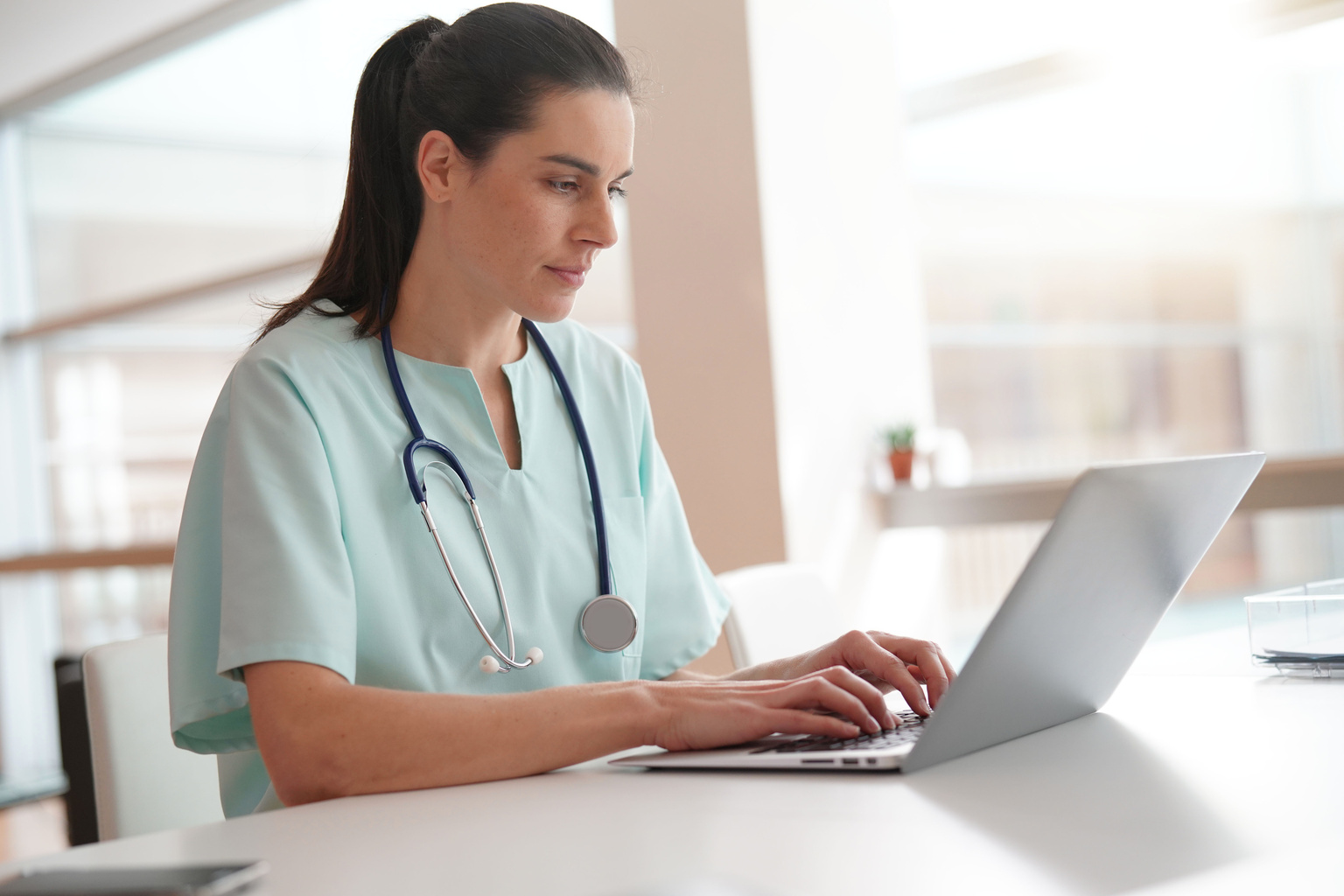 Nurse working on laptop computer