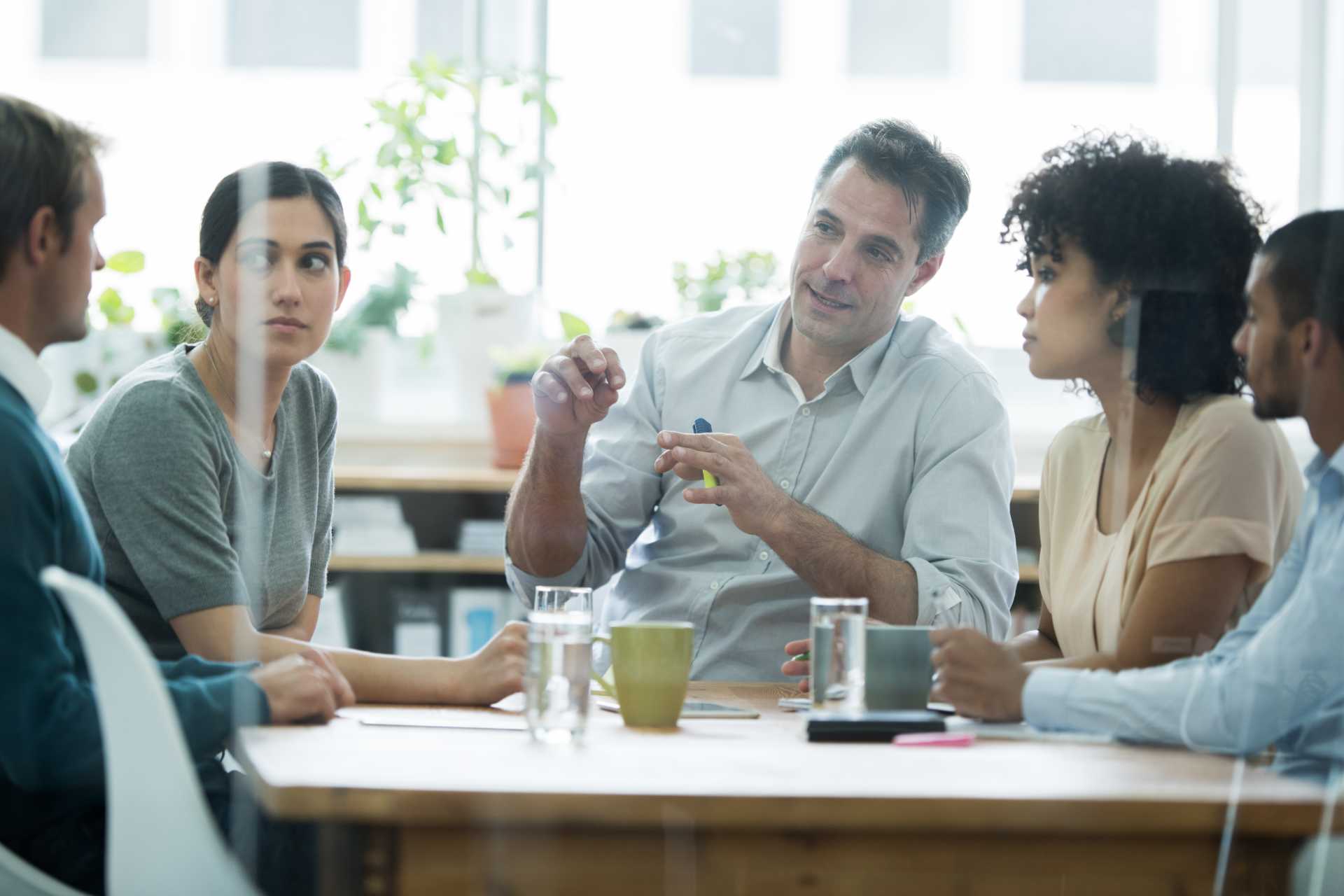 Group of professionals meet at wooden table