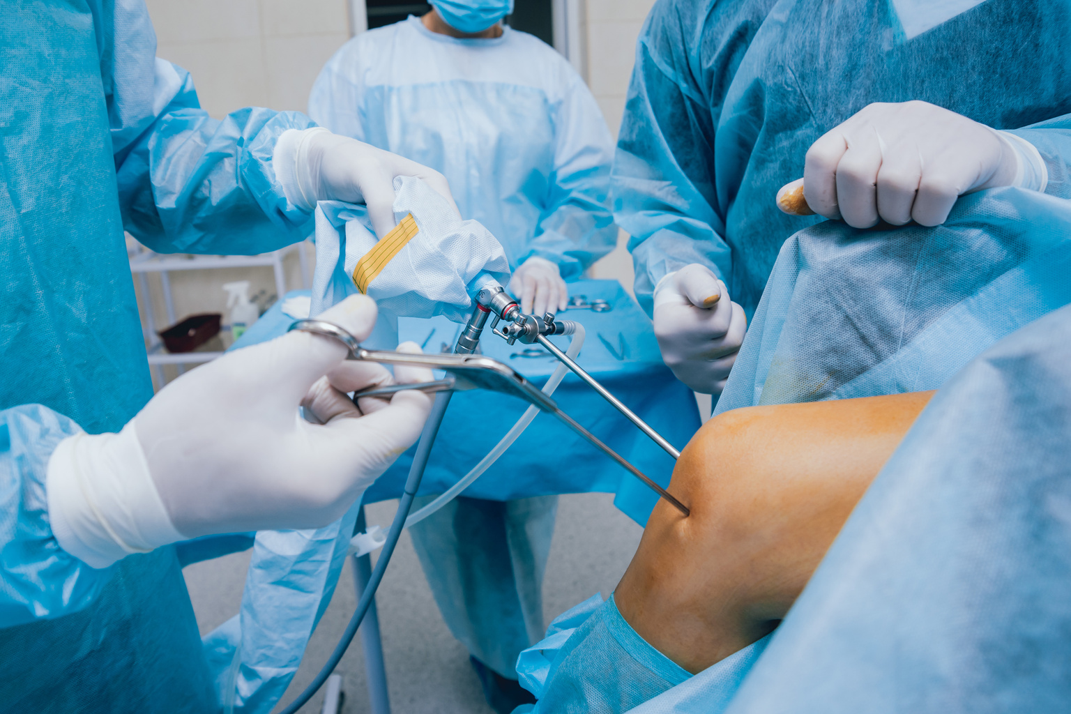 Surgeons performing knee surgery