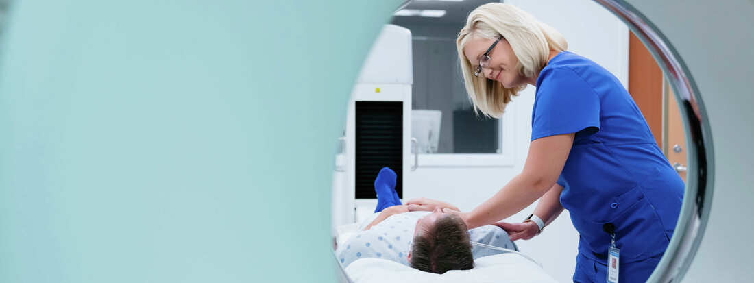 medical professional readies patient for scan