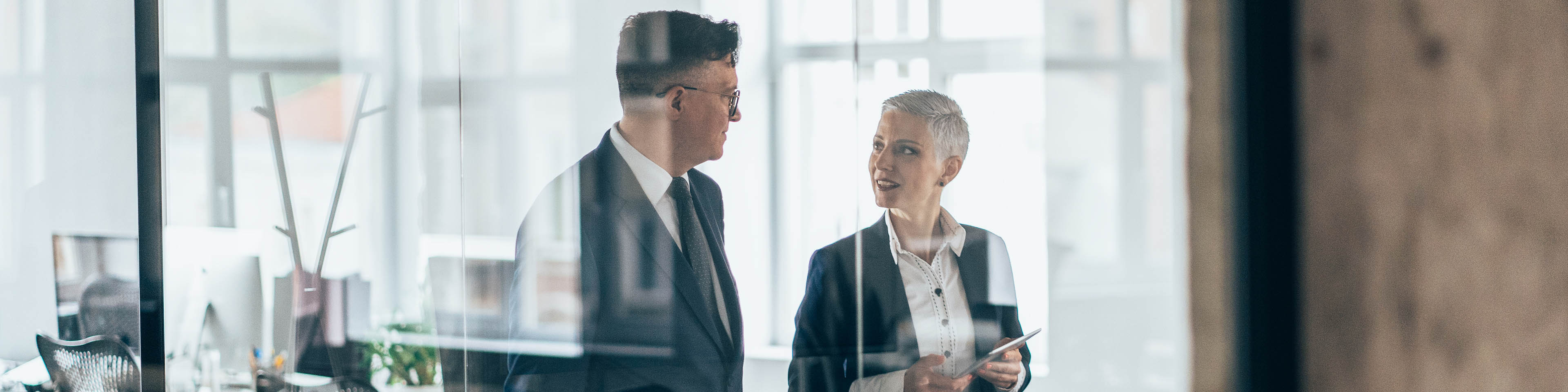 Business people walking and talking discussing ideas in the office