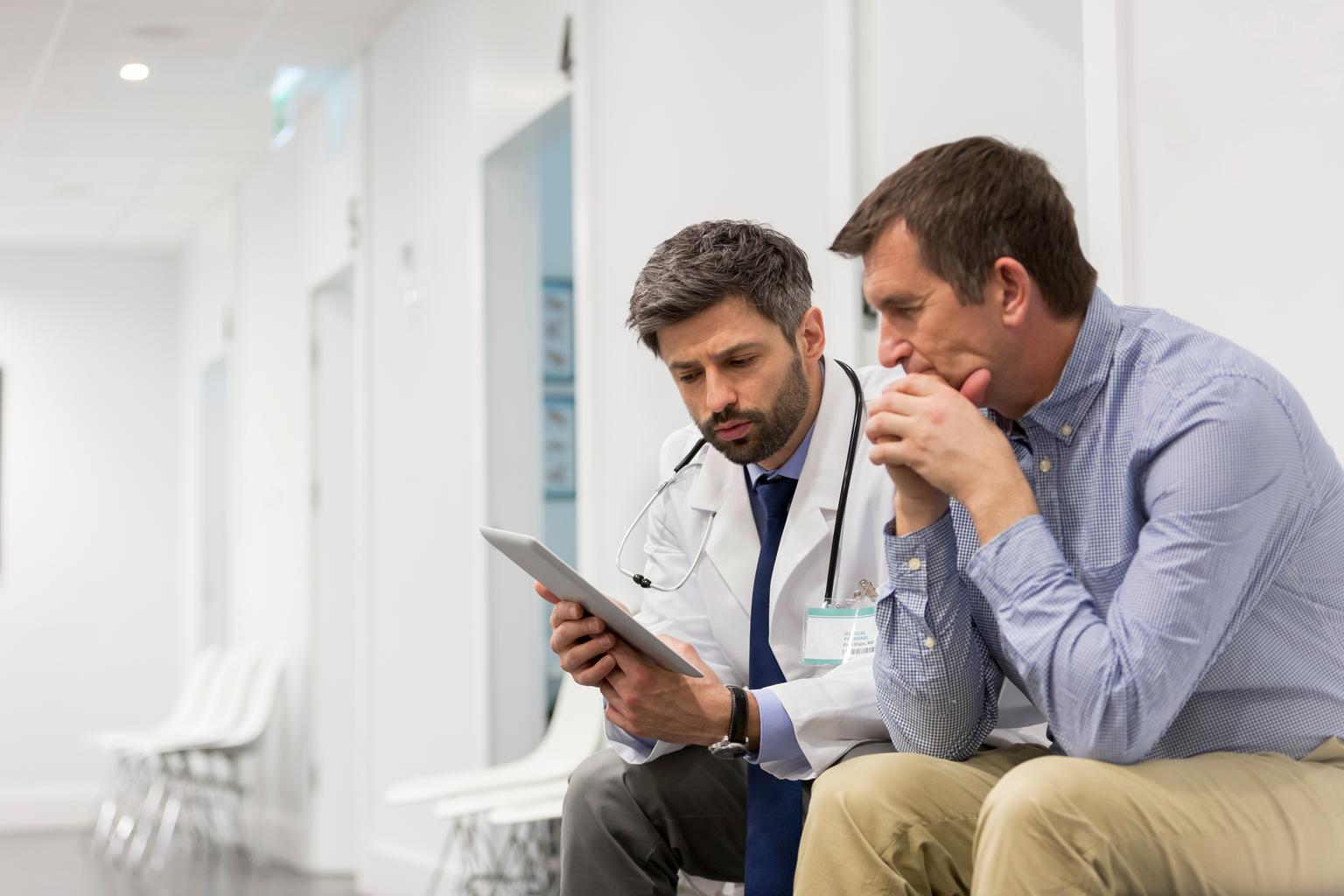Doctor and administrator or patient looking at tablet