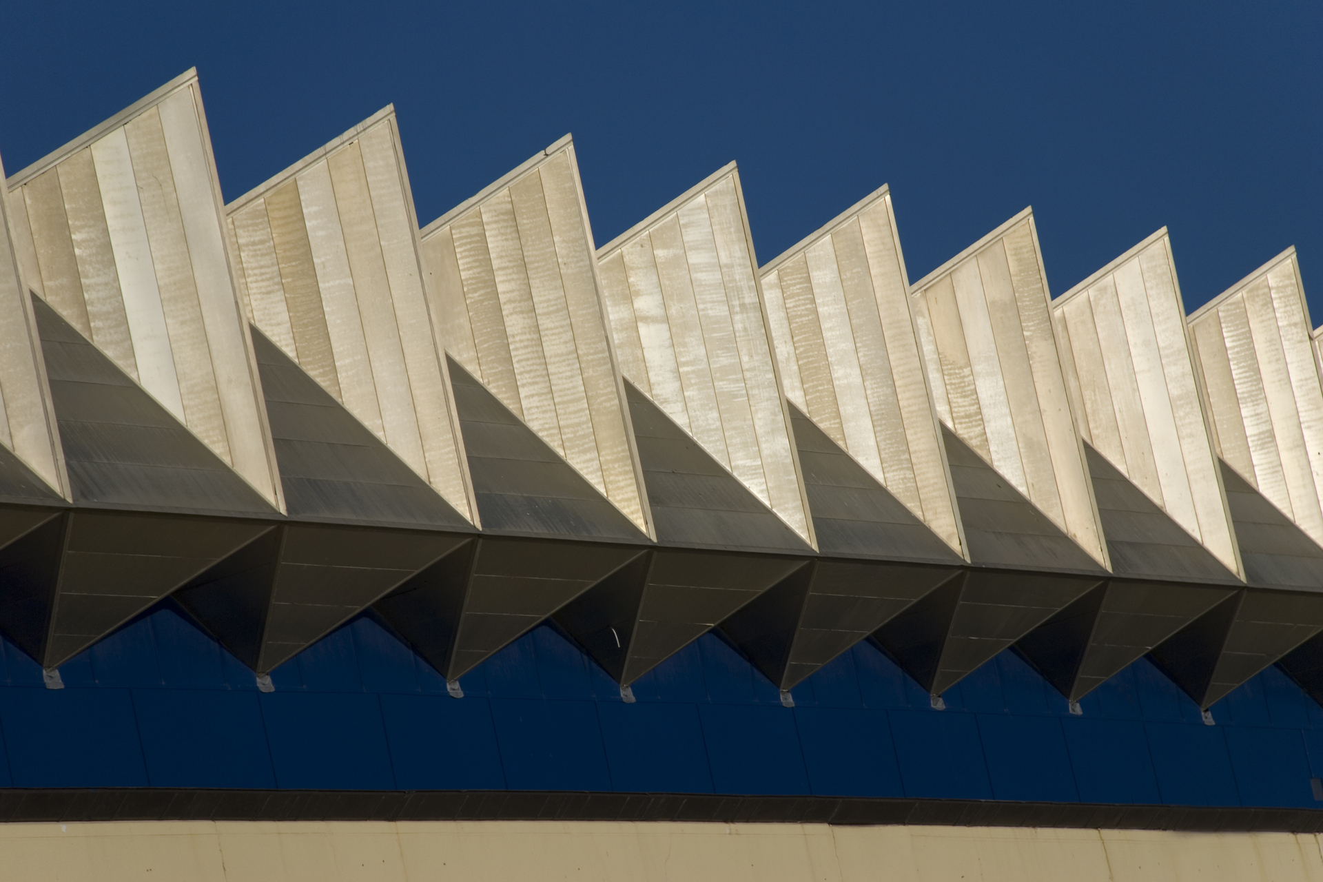Part of a building roofline abstract on a blue sky background in wintertime