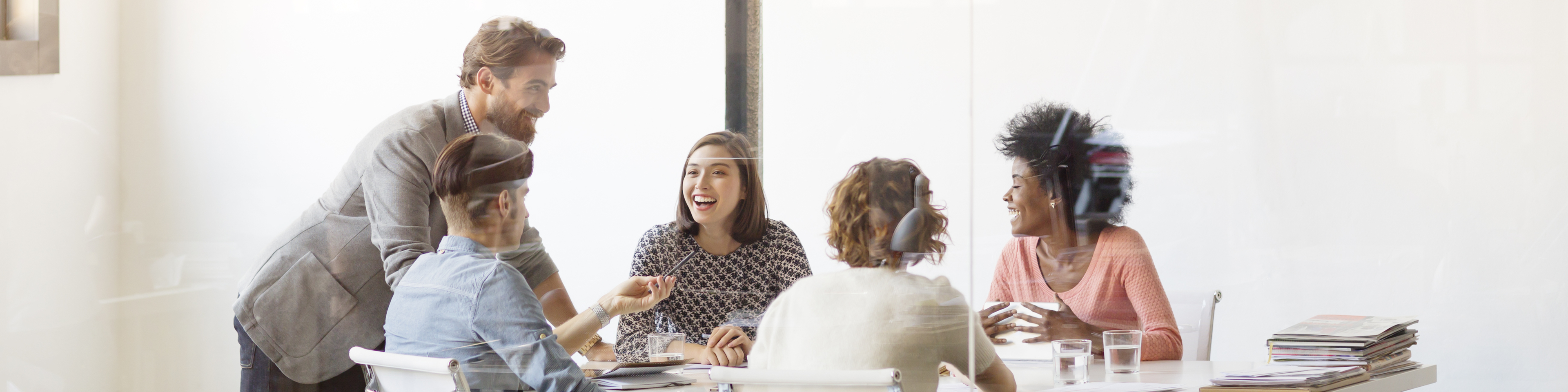 Happy young business colleagues in board room at office