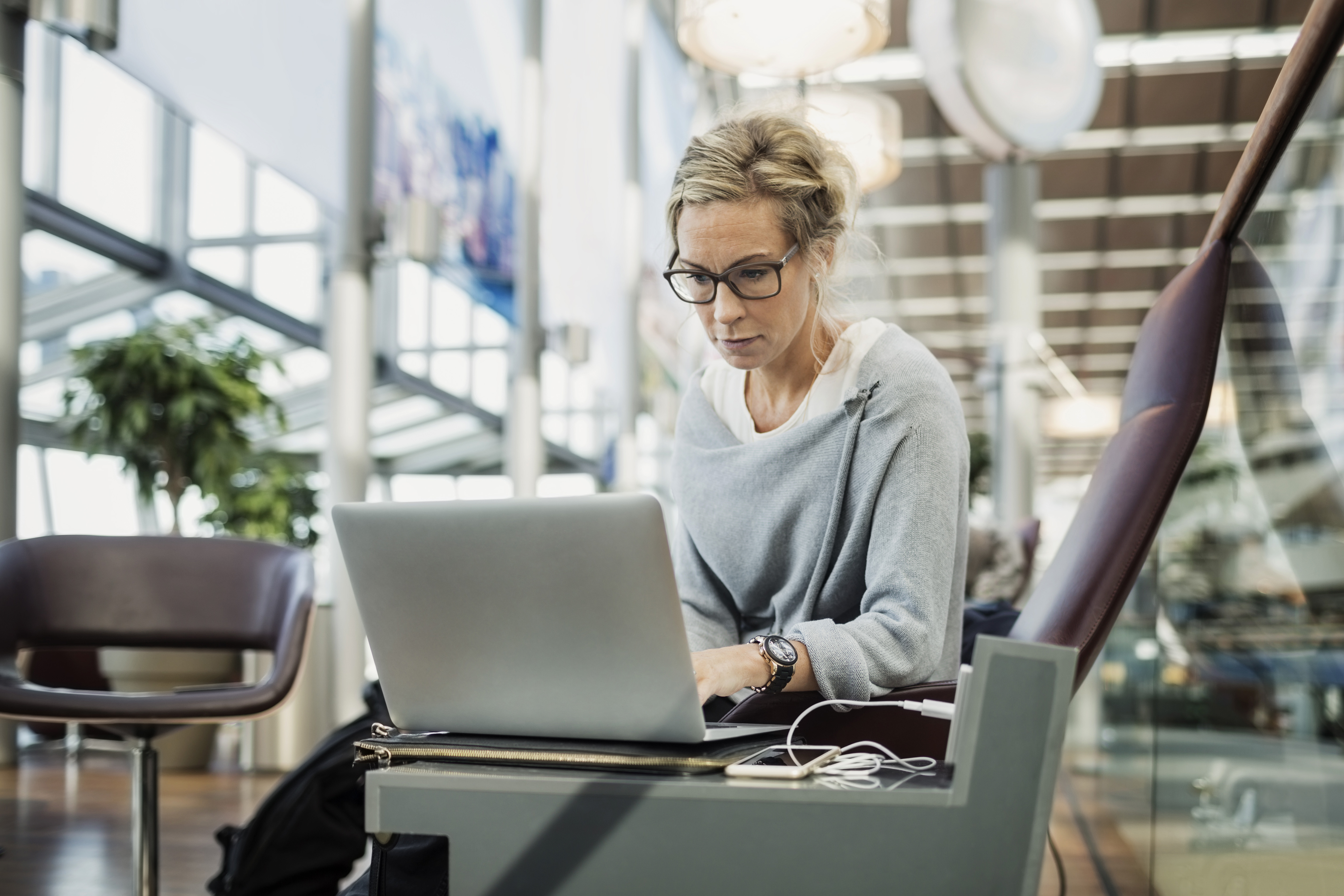 Businesswoman using laptop at Airport