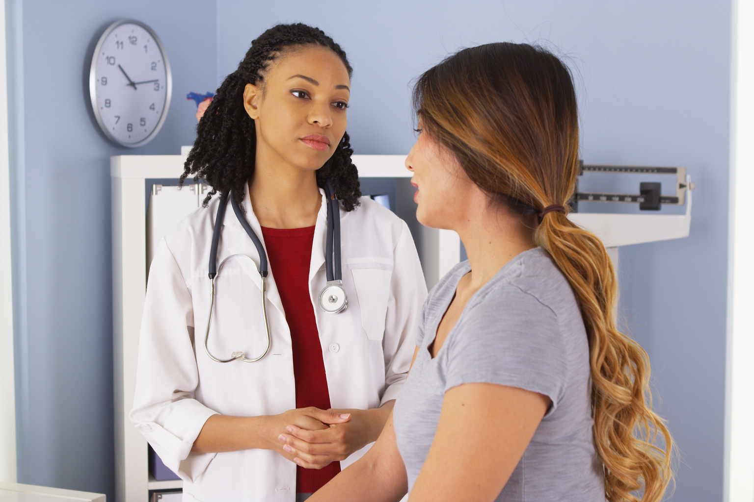 Female doctor speaking with patient in clinic