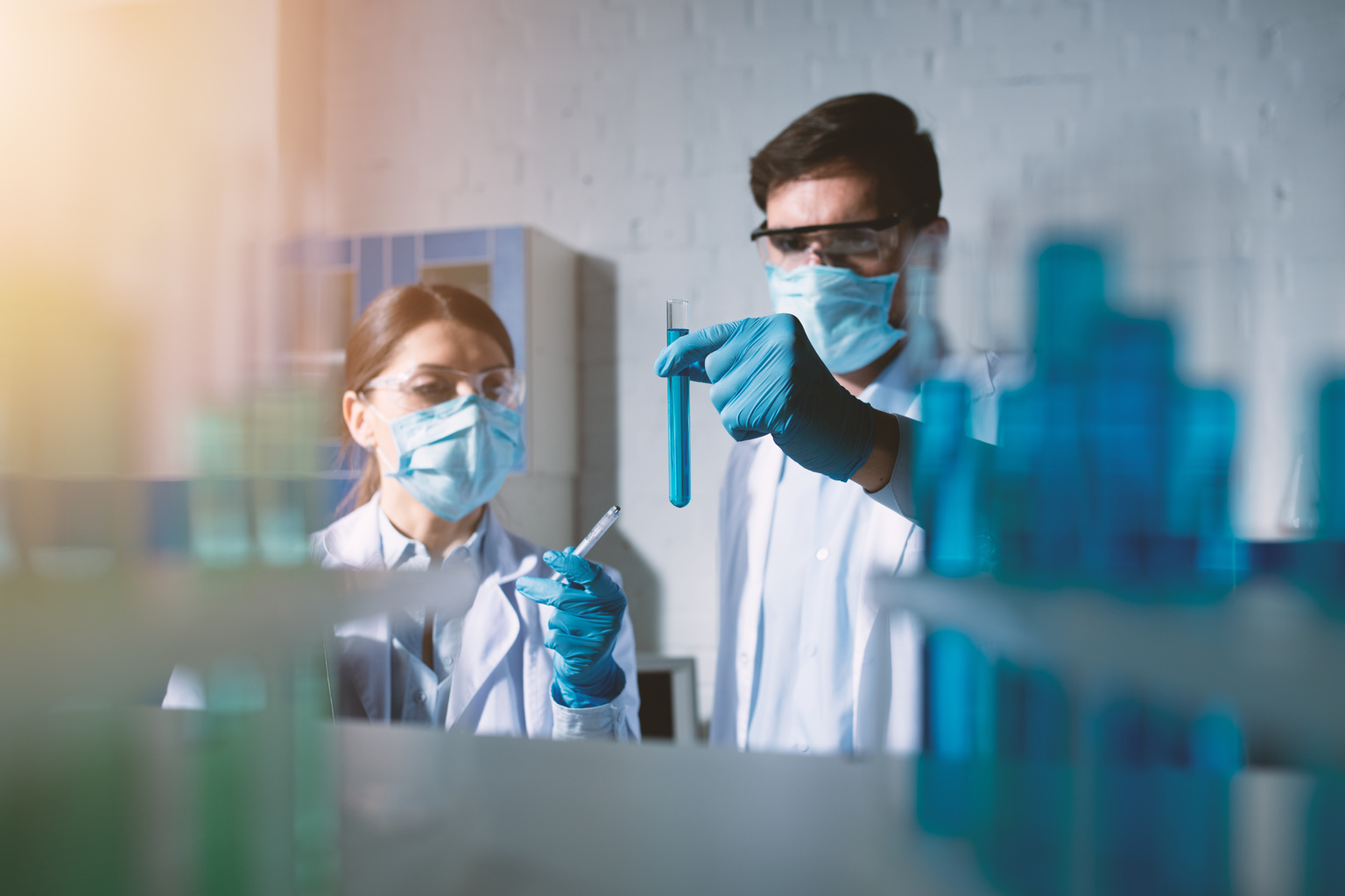 Two researchers examining specimen in a lab