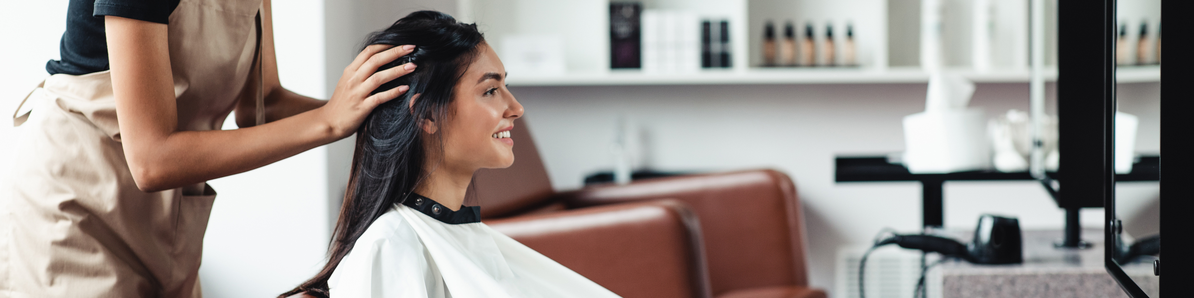 Young woman looking for new hairstyle at beauty salon