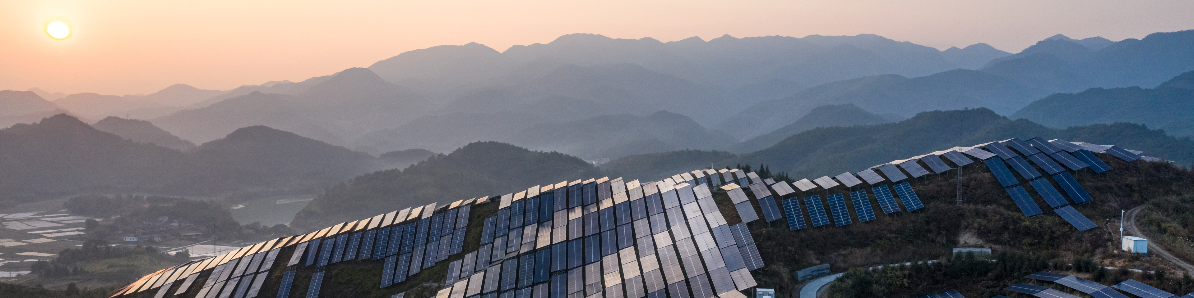 Aerial view of the solar power plant on the top of the mountain at sunset, 