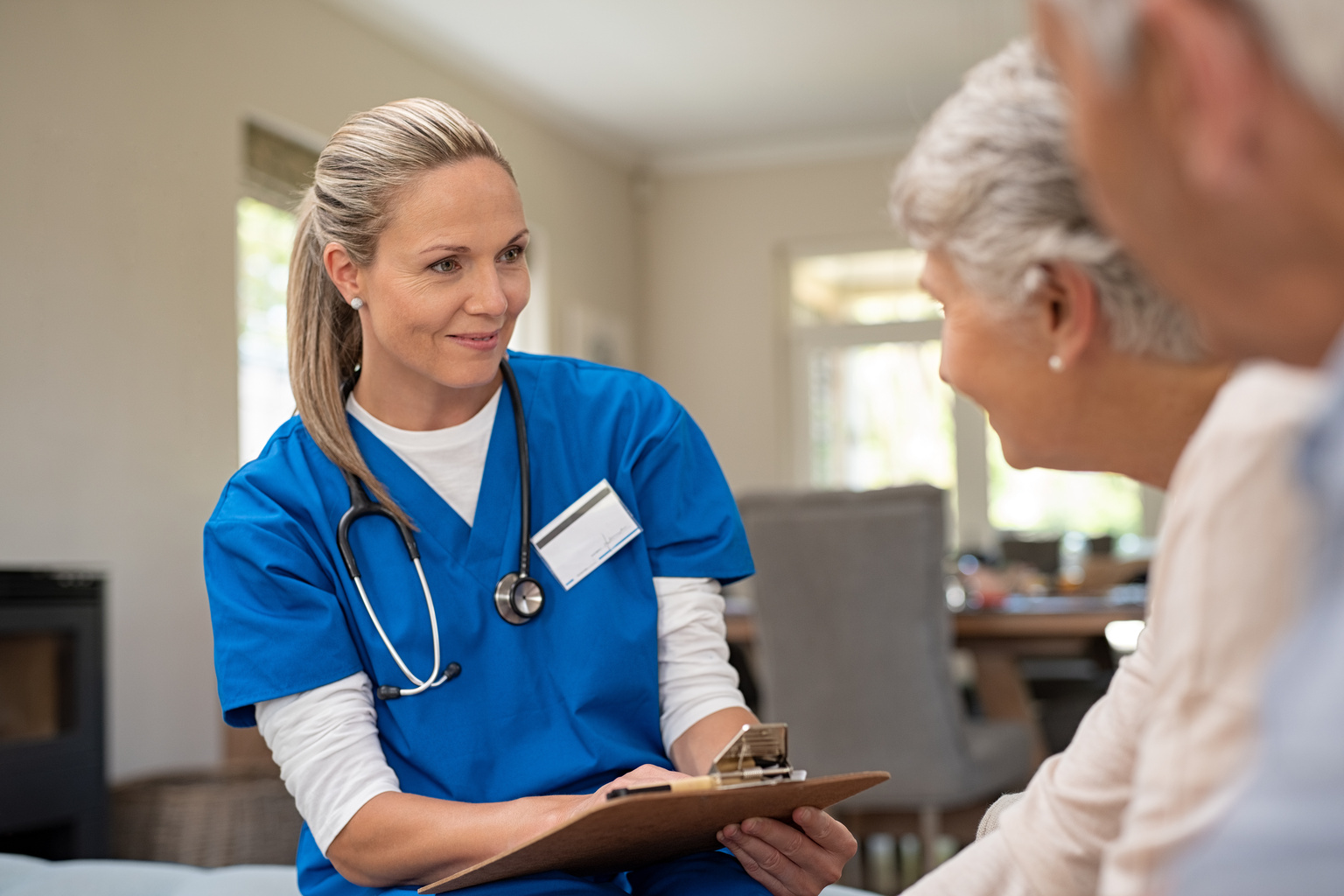 Friendly nurse talking with older couple