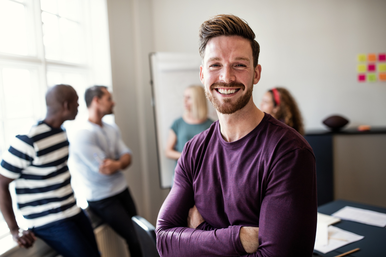 Smiling young designer standing in an office after a presentation