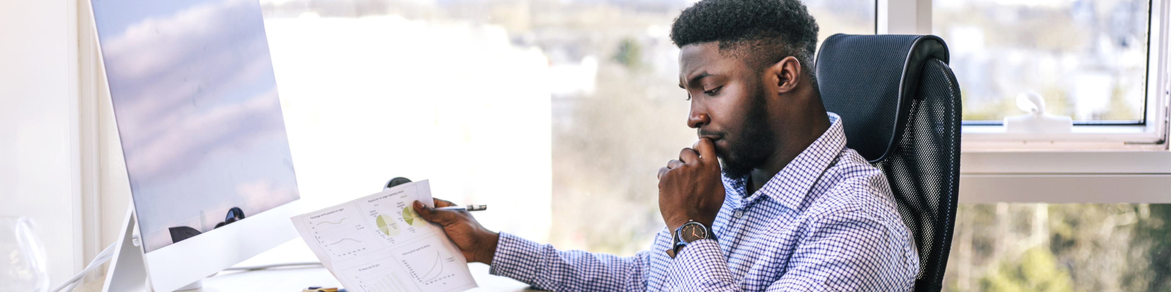 Successful African businessman working on computer in his office