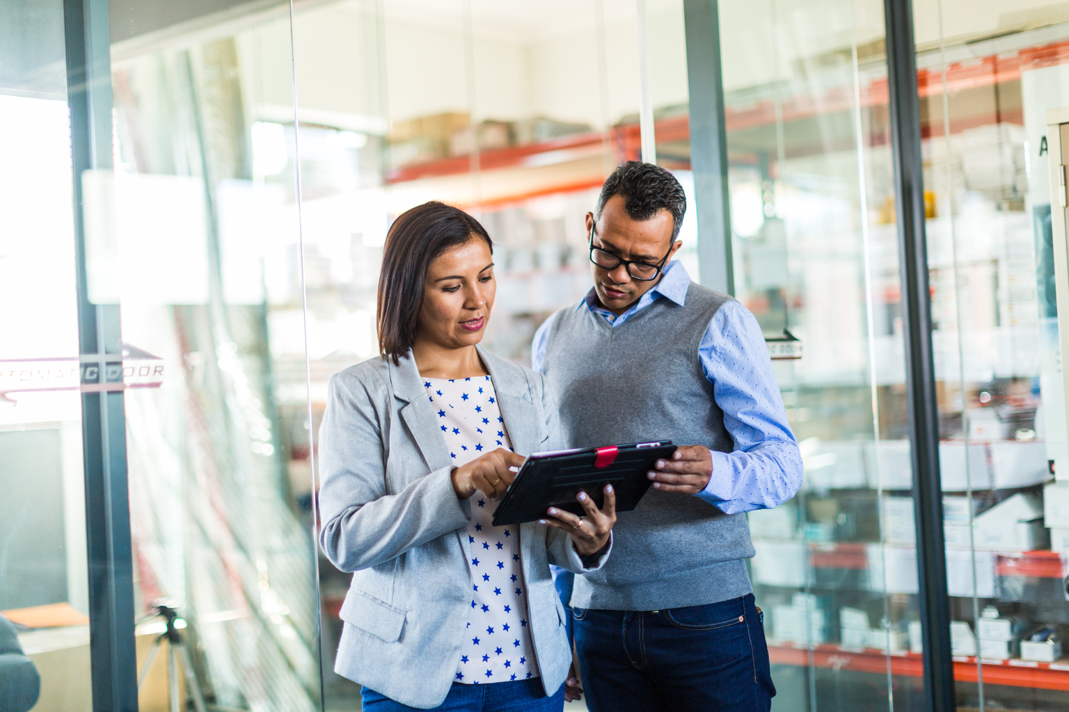 Two business colleagues reviewing tablet.