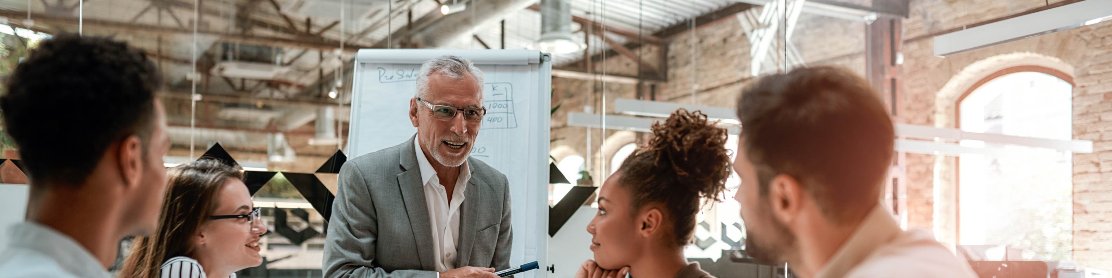 5 business people having a discussion during a meeting