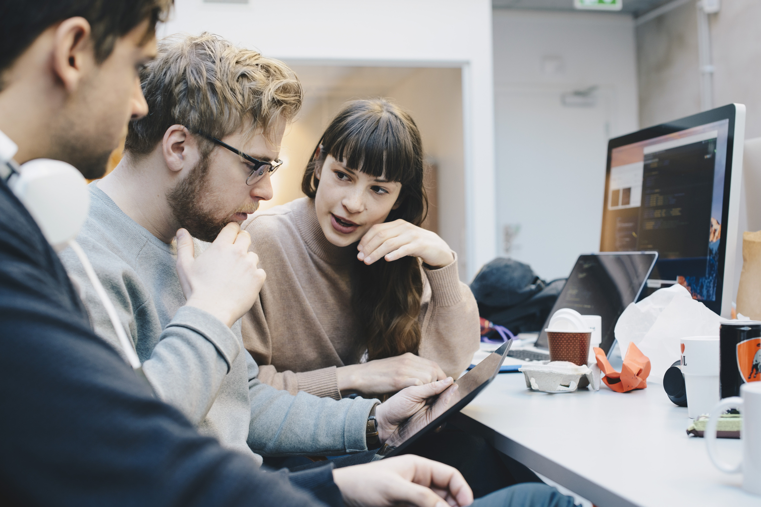 Businesswoman and businessman using computer and brainstorming.