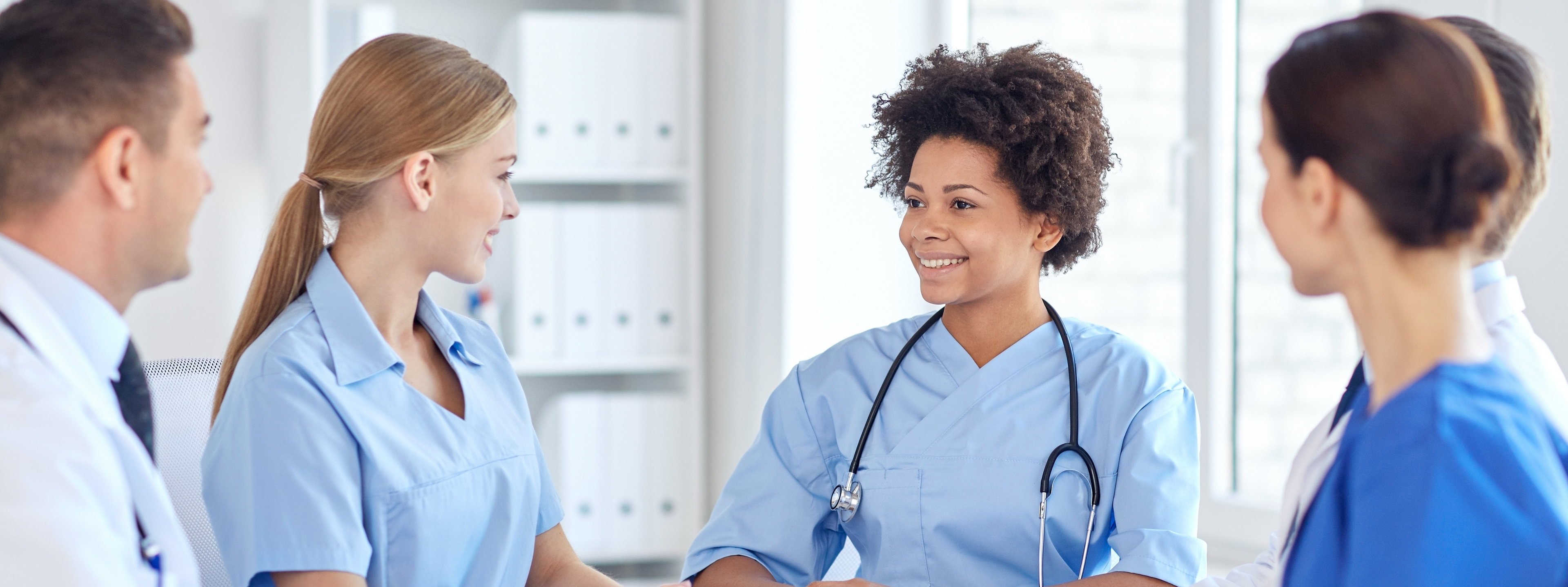 Group of happy doctors meeting at hospital office