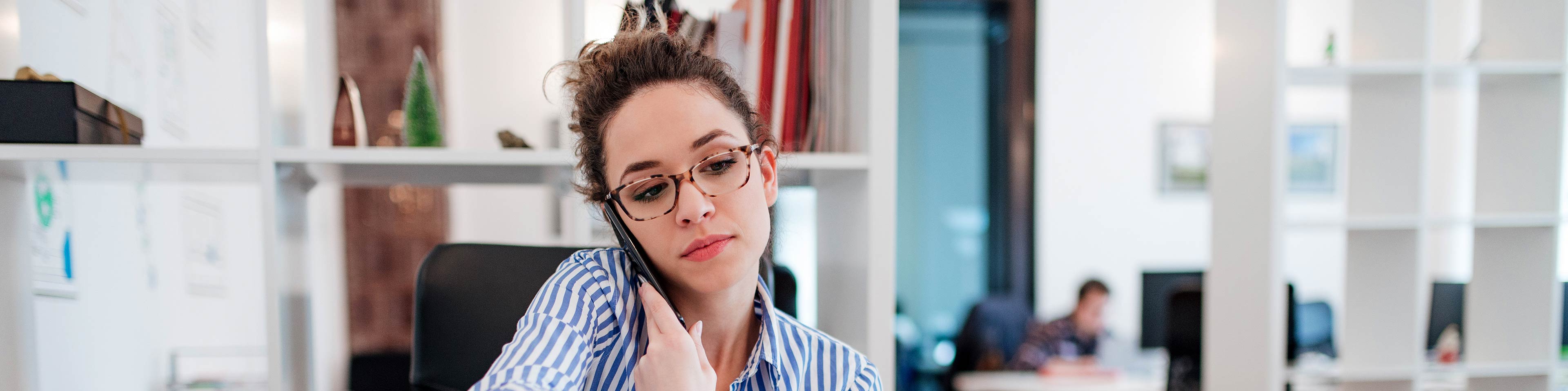 Woman working from home, talking on the phone