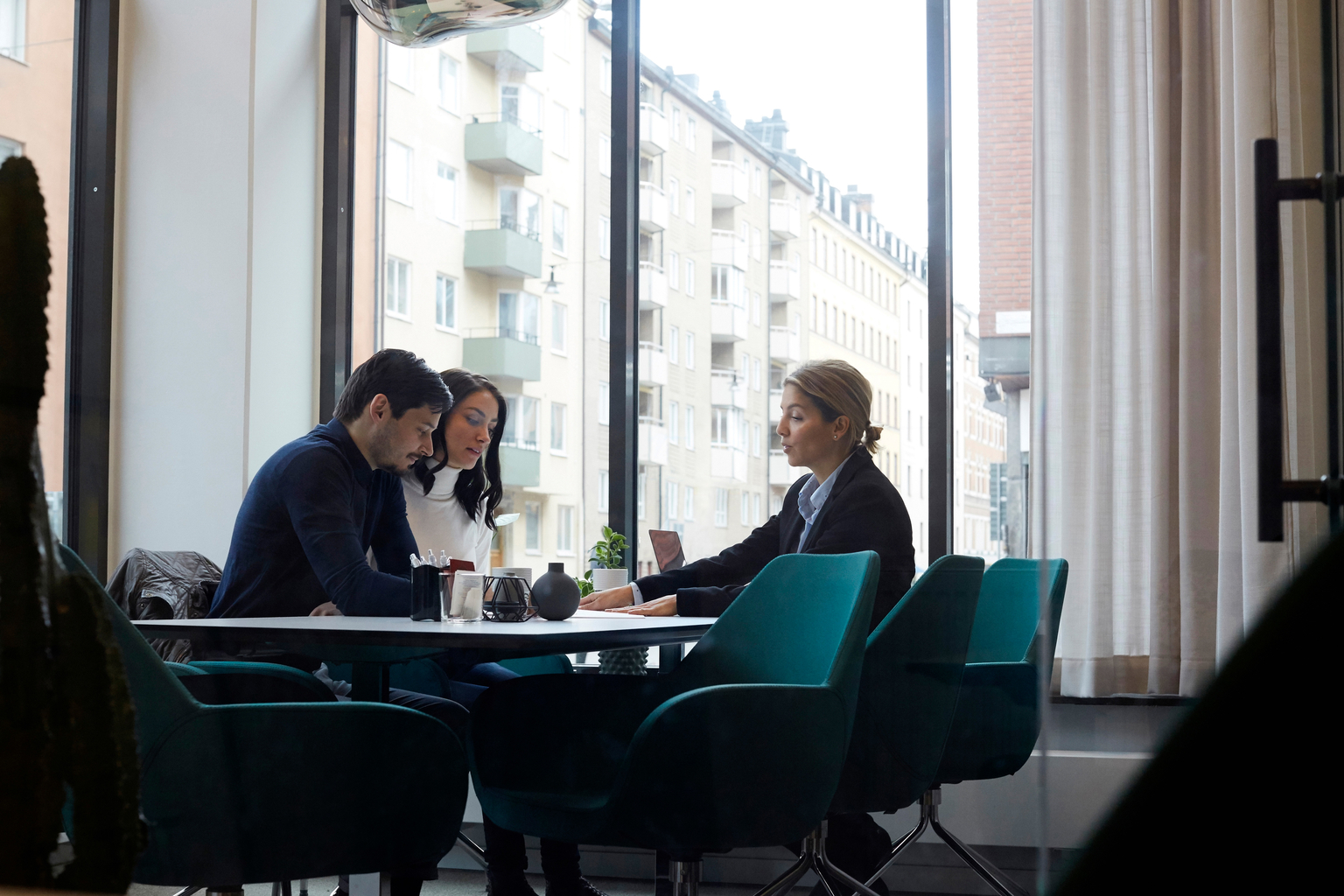 Real estate agent discussing with couple in office