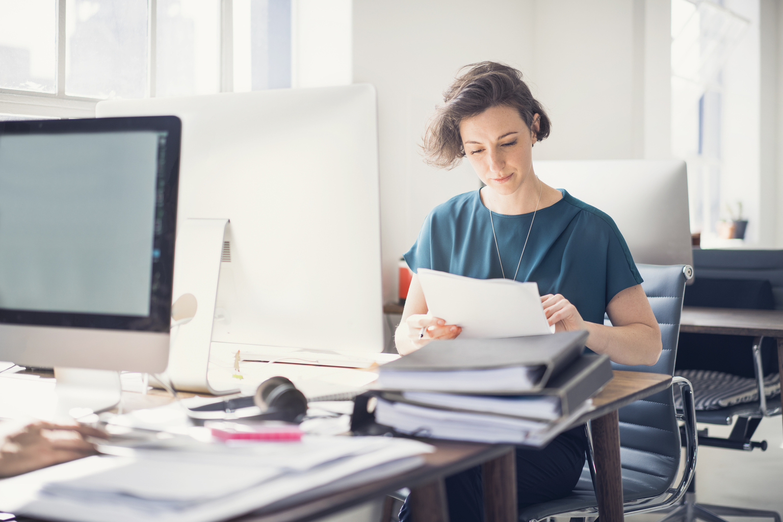 Businesswoman reviewing paperwork in office