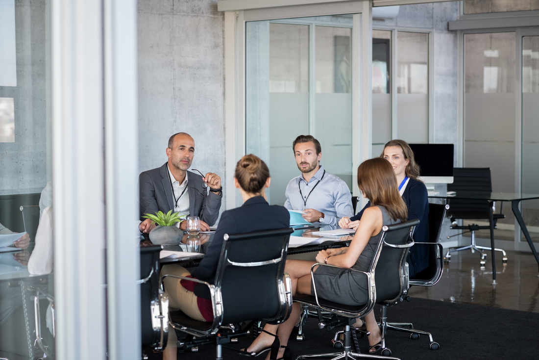 Business people sitting in boardroom and working together at new strategy plan. Group of leader and businesspeople in a meeting at office. Senior executive with his team working in a conference room.