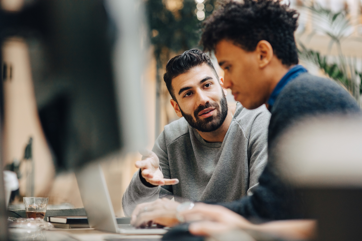 Two men colleagues working together at workplace