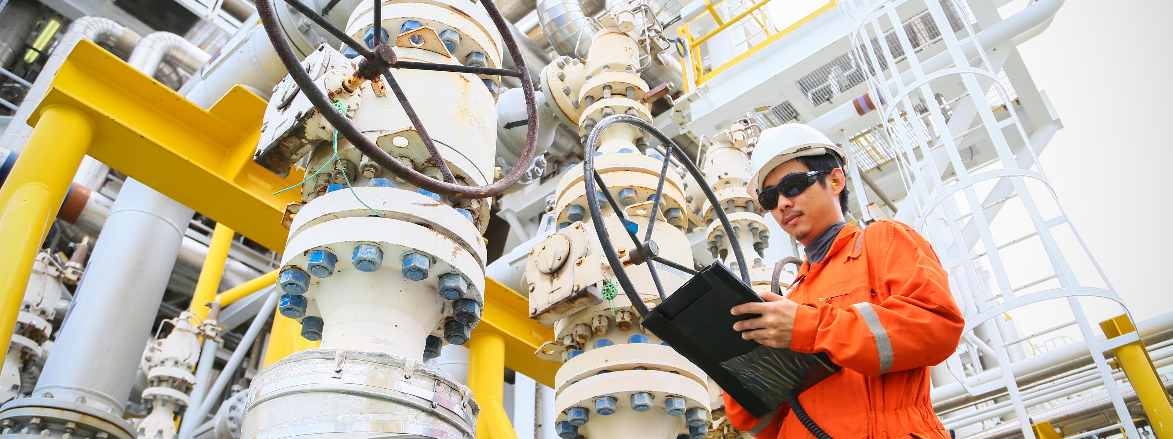 operator recording operation of oil and gas process at oil and rig plant, offshore oil and gas industry, offshore oil and rig in the sea, operator monitor production process, routine daily record.