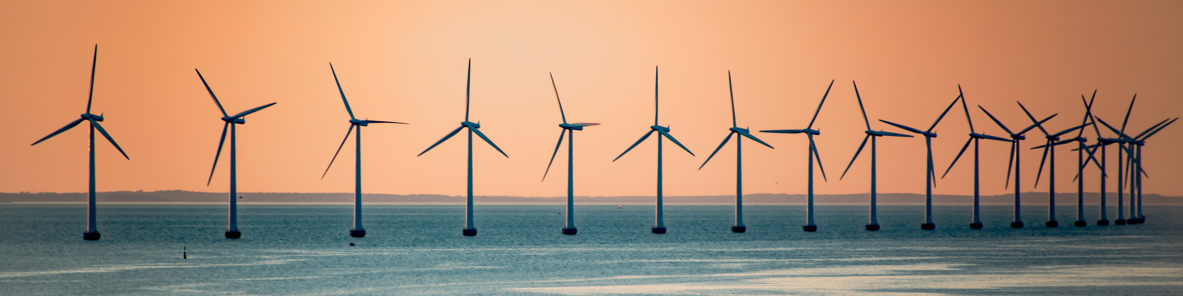 Wind turbines in windmill farm producing alternative energy in kopenhagen